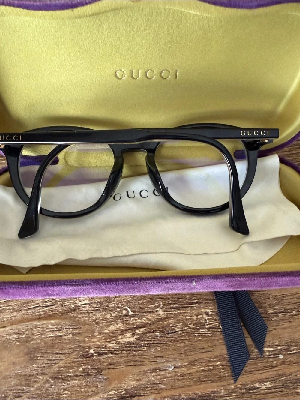 Gucci Black Round Optical Glasses with purple case, dust bag, and cleaning cloth